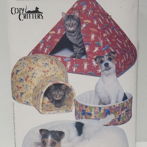 May include: A sewing pattern for making pet beds. The pattern is for a cat bed, a dog bed, and a dog bed with a pillow. The pattern is from Butterick and is number 5903. The pattern is called "Cozy Critters".