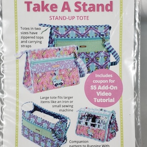 May include: An image of a pattern for a stand-up tote bag is displayed. The design showcases different tote bag styles with zipped tops and carrying straps. The text reads "Take A Stand" and "Zippered totes open wide for easy access."