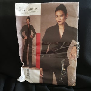 May include: A black and white sewing pattern for a women's suit by Guy Laroche. The pattern is for a jacket and trousers. The pattern is Vogue Patterns Paris Original V1143.