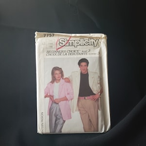 May include: Simplicity sewing pattern number 7757, Beginner's Choice level 3, for a blazer and trousers. The pattern features a woman wearing a pink blazer and grey trousers, and a man wearing a white blazer and khaki trousers.