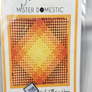 May include: A package featuring a colorful optical illusion weave design. The design is a square pattern of orange, yellow, and brown squares. The text "Mister Domestic" is at the top, and "Optical Illusion Weave" is at the bottom.