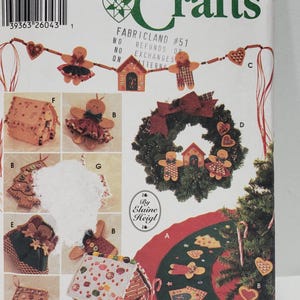 May include: A Simplicity Crafts pattern for making gingerbread house ornaments, a gingerbread house, a gingerbread wreath, and a gingerbread tree skirt. The pattern is number 5891 and is by Elaine Heigl.