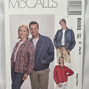 May include: A vintage McCall's sewing pattern with illustrations of jackets. The pattern cover shows a plaid jacket, a navy blue jacket, and a red jacket. The pattern number is 8685.