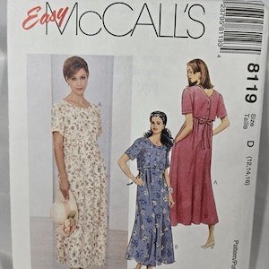 May include: McCall's sewing pattern with three dress designs. The pattern includes a floral print dress, a solid pink dress with a bow, and a blue floral dress. The pattern size is D (12, 14, 16).