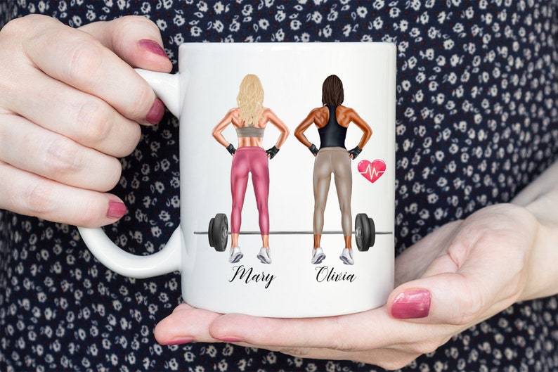 May include: White ceramic mug with a colorful illustration of two women lifting weights. The women are wearing workout clothes and have their names, "Mary" and "Olivia", written below them.