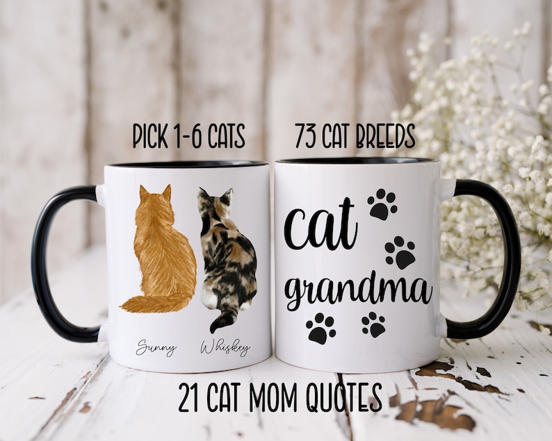 May include: Two white ceramic mugs with black handles and black rims. The mug on the left has a picture of two cats sitting back to back. The mug on the right has the text "cat grandma" with paw prints. The text "PICK 1-6 CATS" is at the top of the mug on the left. The text "73 CAT BREEDS" is at the top of the mug on the right. The text "21 CAT MOM QUOTES" is at the bottom of the mugs.