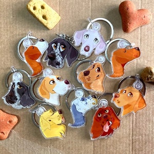 May include: A set of 10 colourful dog breed keyrings. Each keyring features a different dog breed with a unique design and colour scheme. The keyrings are made of durable plastic and have a metal ring for attaching to keys or bags.