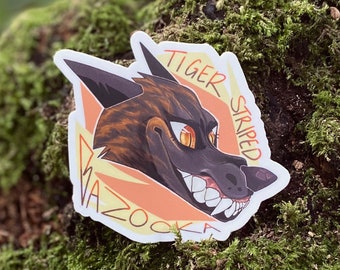 May include: A sticker featuring a cartoon tiger with orange and black stripes. The tiger has a toothy grin and is set against a yellow and orange background. The text "Tiger Striped" and "Vazooka" are written around the tiger.