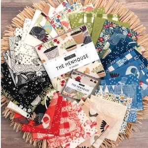 May include: A collection of fabric squares in various colors and patterns, including floral, geometric, and bird designs. The fabric is arranged on a woven straw mat. The text "THE HENHOUSE" is visible on a label.