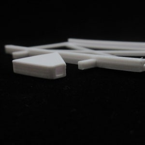May include: White plastic model train track pieces. The track is curved and straight. The pieces are designed to connect together to create a model train layout.