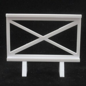 May include: White plastic fence with a criss-cross pattern and two legs. The fence is about 10 inches tall.
