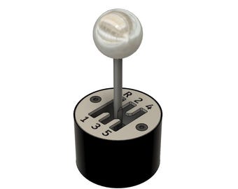 May include: A black gear shift knob with a white ball on top. The knob has the numbers 1, 3, 5, R, N, and 4 printed on it.