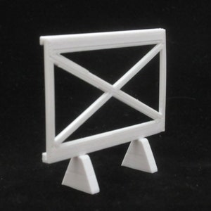 May include: White plastic model of a fence with a criss-cross pattern and two triangular bases.