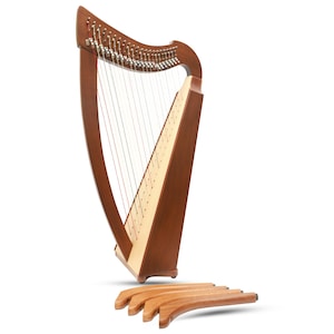 May include: A wooden harp with a dark brown finish, featuring strings and a light-coloured soundboard. The harp is standing upright, with four detached wooden feet resting below. The instrument is designed for musical performance.