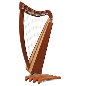 May include: A wooden Celtic harp with strings and a natural wood finish. The harp is standing on a set of four wooden legs.