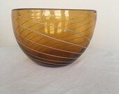 A vintage hand- blown Italian Murano glass amber- coloured bowl with white swerves
