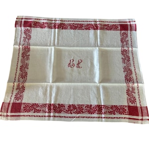 May include: White linen towel with a red floral border and matching corner accents. The towel features the embroidered initials "E L" in the center. The red border is a repeating floral pattern. The towel is folded neatly.