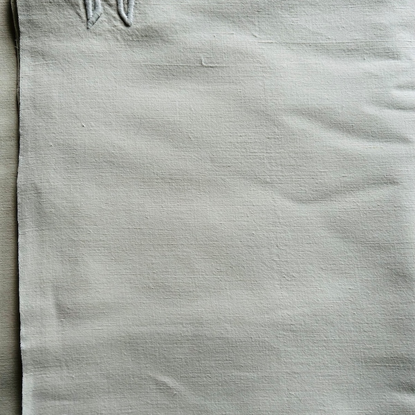 A vintage 1930’s unused French métis linen plain white farmhouse sheet with a white corner monogram L D.