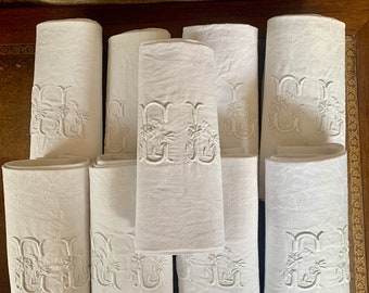 A set of nine antique French white damask linen napkins with an embroidered monogram, circa 1910