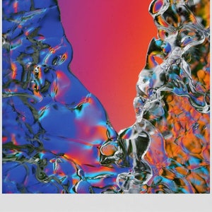 May include: Abstract art print in a gray frame. The artwork features a vibrant composition of blue, orange, and purple hues, with a dynamic, fluid appearance. The colors blend and contrast, creating a visually striking and modern piece.