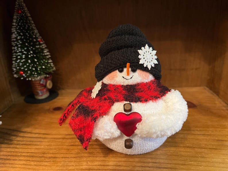 Snowmen,sock penguins and sock bunnies. Black hat/heart