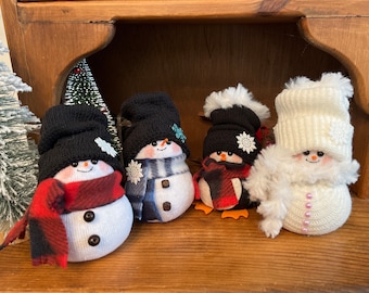 Mini snowman, mini snow girl, and mini penguins.