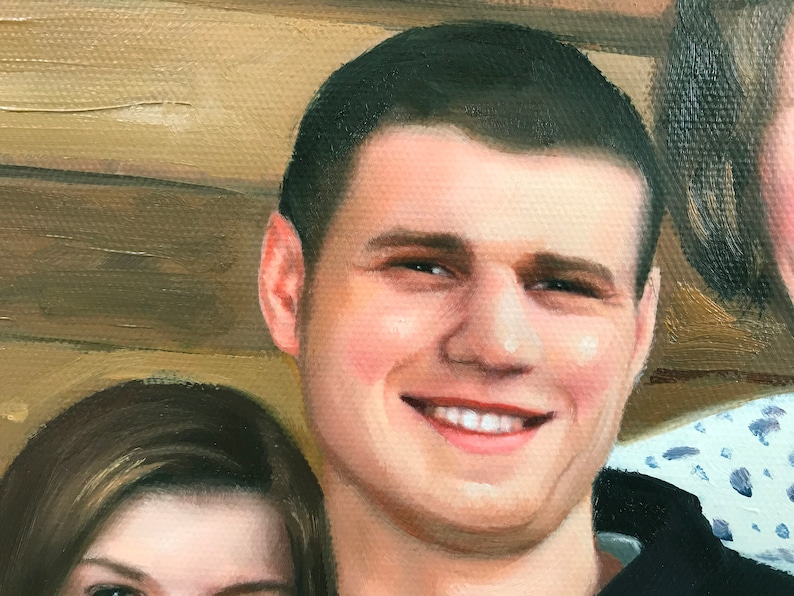 May include: A close-up portrait of a man with short brown hair. He is smiling and has a light complexion. He is wearing a black shirt.