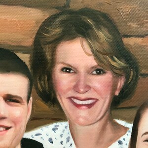 May include: A close-up portrait painting of a family. The woman in the center has short, light brown hair and is smiling. She is wearing a white shirt with a blue pattern. The man on the left has short, dark brown hair and is also smiling. The young girl on the right has long, dark brown hair and is looking at the camera.