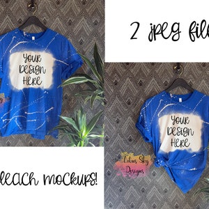 May include: Two blue t-shirts with a white bleached area in the center. The text "Your Design Here" is written in black on the bleached area of each shirt. The shirts are hanging on hangers against a patterned background.