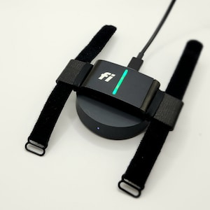 The Fi Series 3 collar adapter on the charging station