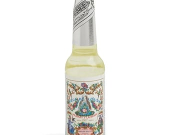 May include: A clear glass bottle filled with a pale yellow liquid, featuring a silver foil neck wrap and a decorative label. The label displays the text Agua de Florida, Murray y Lanman, New York, Peru, surrounded by colorful floral illustrations.