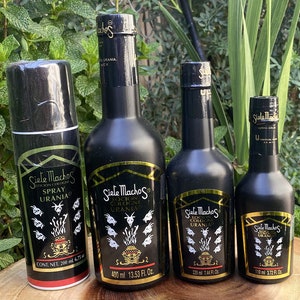 May include: An assortment of Siete Machos cologne and spray bottles. The bottles are black with gold accents and labels featuring the brand name and goat illustrations. Sizes include 200 ml spray, 400 ml, 220 ml, and 110 ml bottles.
