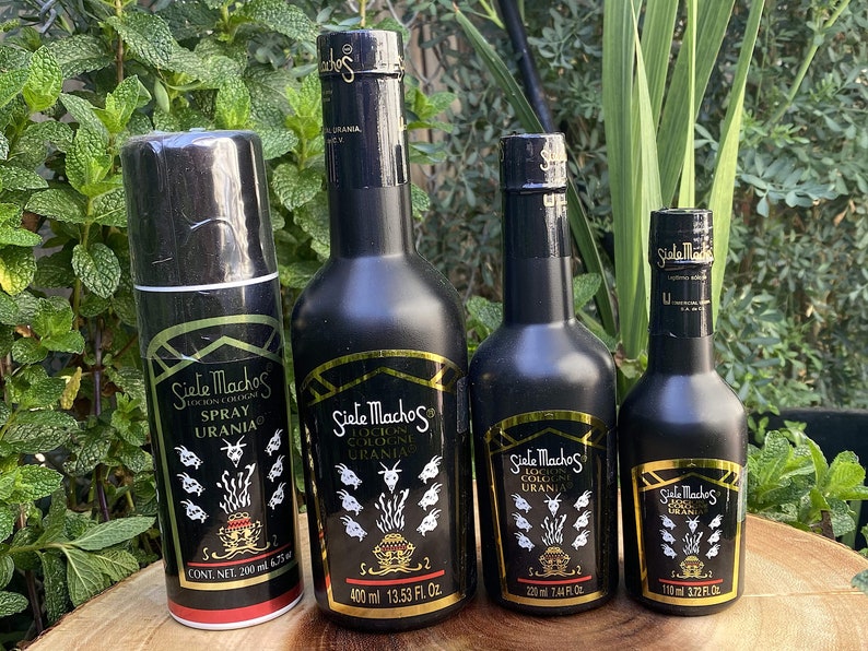 May include: An assortment of Siete Machos cologne and spray bottles. The bottles are black with gold accents and labels featuring the brand name and goat illustrations. Sizes include 200 ml spray, 400 ml, 220 ml, and 110 ml bottles.