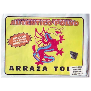 May include: A yellow packet with the words "AUTENTICO POLVO" in red block letters. A red and blue dragon graphic is in the center. The text "POLVOS CON COLOR ORIGINAL" is in a starburst. The bottom text reads "ARRAZA TOL".