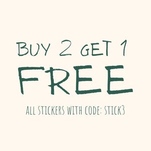 May include: Cream-colored background with dark green text that reads "BUY 2 GET 1 FREE". Below, the text states "ALL STICKERS WITH CODE: STICK3". The text is in a handwritten style.