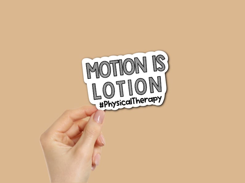 May include: A white sticker with the text "MOTION IS LOTION" in black, outlined in black. Below the text is the hashtag "#PhysicalTherapy". The sticker is held by a hand against a tan background.