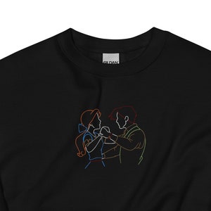 May include: Black sweatshirt with a colorful line drawing of a couple dancing.