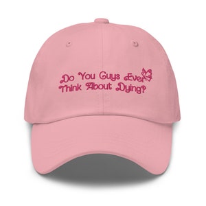 May include: Pink baseball cap with embroidered text "Do You Guys Ever Think About Dying?" and a small butterfly graphic.