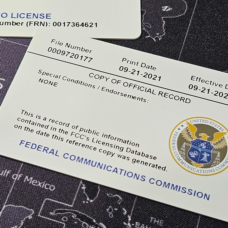 May include: A white card with the text "COPY OF OFFICIAL RECORD" and the seal of the Federal Communications Commission. The card includes the text "File Number 0009720177", "Print Date 09-21-2021", and "Effective Date 09-21-2021".