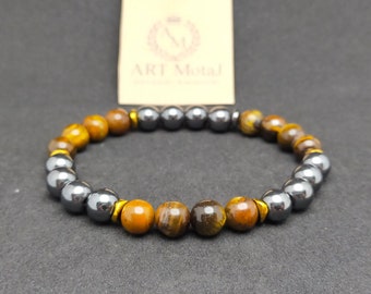 May include: A bracelet made of brown tiger's eye and black hematite beads. The bracelet has gold accents between the beads.