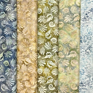 May include: A collection of six fabric panels with a seashell and starfish pattern. The fabrics feature a variety of colors, including blue, green, and tan. The seashell designs are white, and the fabrics are suitable for various craft projects.