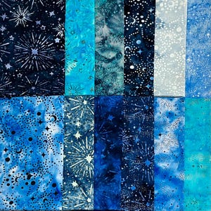 May include: A collection of fabric swatches in shades of blue, featuring celestial patterns. Designs include starbursts, moons, and scattered dots. The fabrics vary in tone from deep navy to light turquoise, creating a night sky theme.