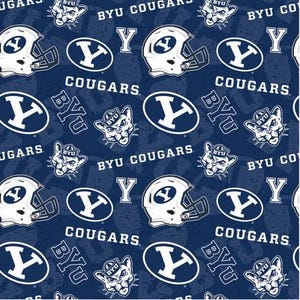 May include: A blue and white fabric with a repeating pattern of the BYU Cougars logo, the letters BYU, and the words "BYU Cougars".