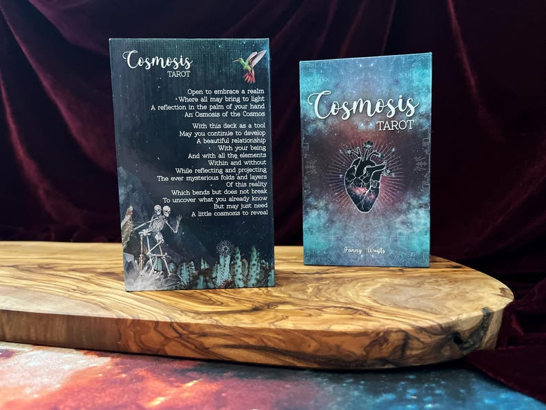 May include: Two rectangular tarot card boxes titled Cosmosis Tarot. The left box features a poem, a hummingbird, and skeleton figures. The right box displays a central anatomical heart illustration with radiating lines against a teal and purple nebula background.
