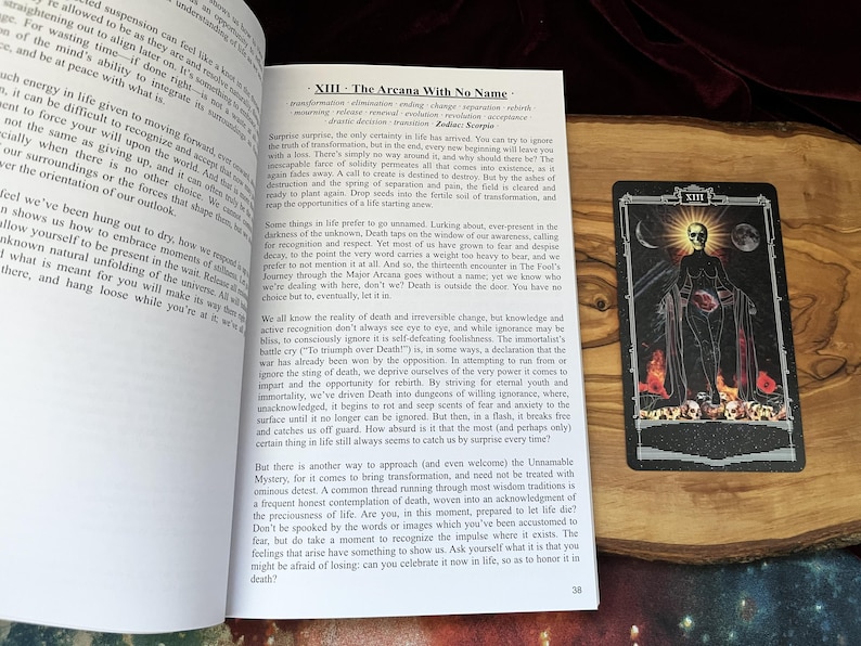 May include: An open book with text titled XIII - The Arcana With No Name and a tarot card featuring a skeletal figure in a black robe, a glowing sun, a crescent moon, and a pile of skulls at the base, set against a dark, starry background.