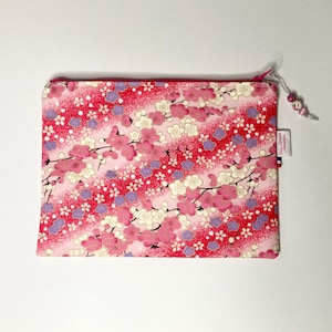 Small pink Japanese fabric pouch with mauve, pink and white flower patterns.