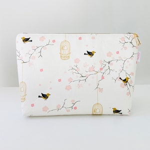 Large toiletry bag in creamy white cotton fabric with Japanese patterns of small cherry blossoms, cages and birds. image 1