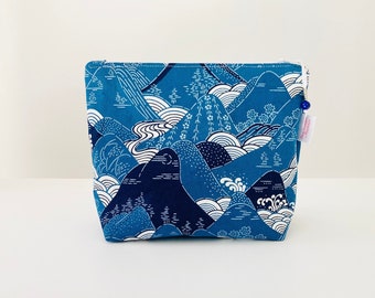 Makeup bag in blue and white Japanese fabric with wave and Mount Fuji patterns.