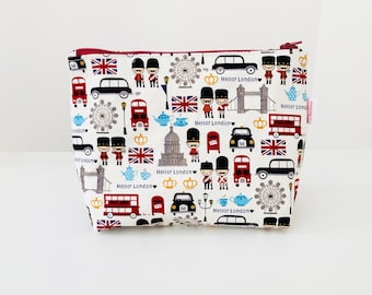 Toiletry bag in off-white fabric with multi-colored London patterns