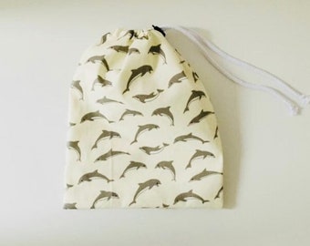 Waterproof bag for wet swimsuits in coated cotton fabric with dolphin patterns